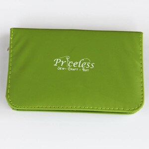 May include: A green zippered pouch with the text "Priceless Sew-Craft-Art" in white.