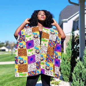 May include: A patchwork kimono featuring a variety of patterns and colours, including zebra print, polka dots, and geometric shapes. The open-front design is worn over a black top and leggings.