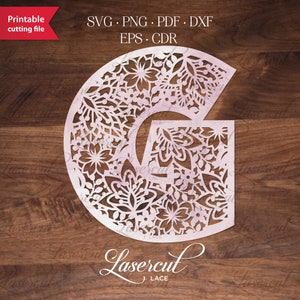 May include: A white, intricate, floral design in the shape of the letter G. The design is reminiscent of lace and is perfect for laser cutting.