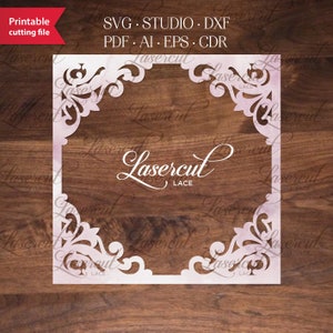 May include: A white, intricate, laser-cut frame with a floral design. The frame is on a wooden background and has the text "Lasercut Lace" in the center.