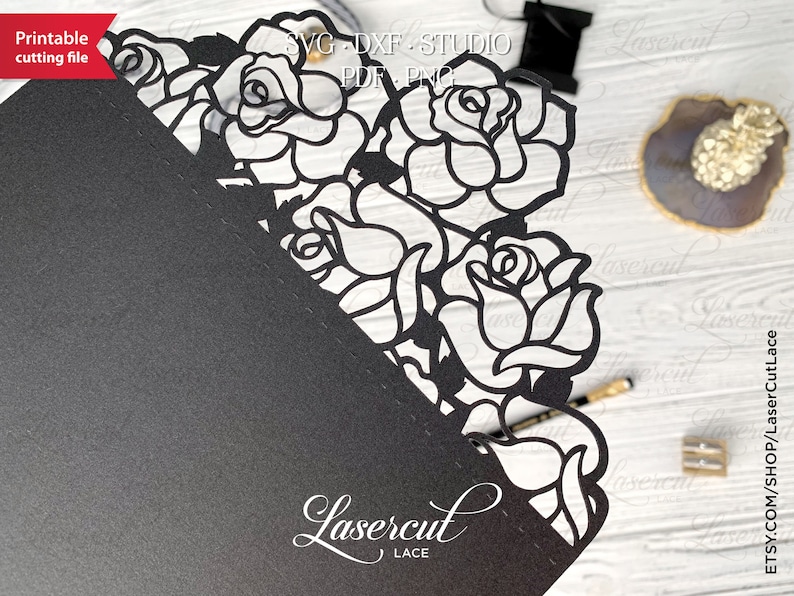 May include: Black and white digital file of a laser cut design featuring a corner border of roses. The design is labeled "Lasercut Lace".