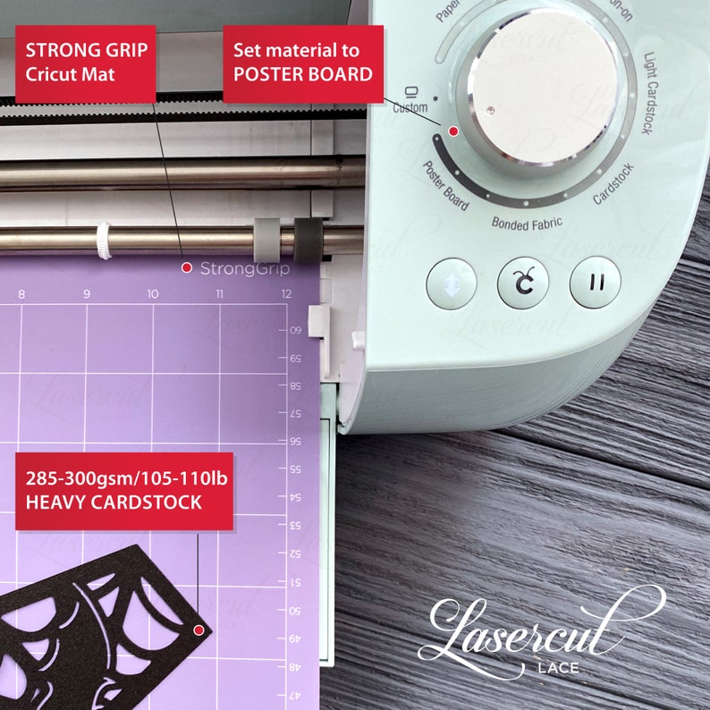 May include: A close-up of a Cricut machine with a purple cutting mat and a black design cut out of heavy cardstock. The machine's control panel shows the material setting is set to "Poster Board".