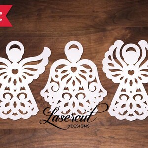 May include: Three white paper cut-out angel ornaments with intricate designs. Each angel has a heart in the center of its chest and wings with a decorative pattern.