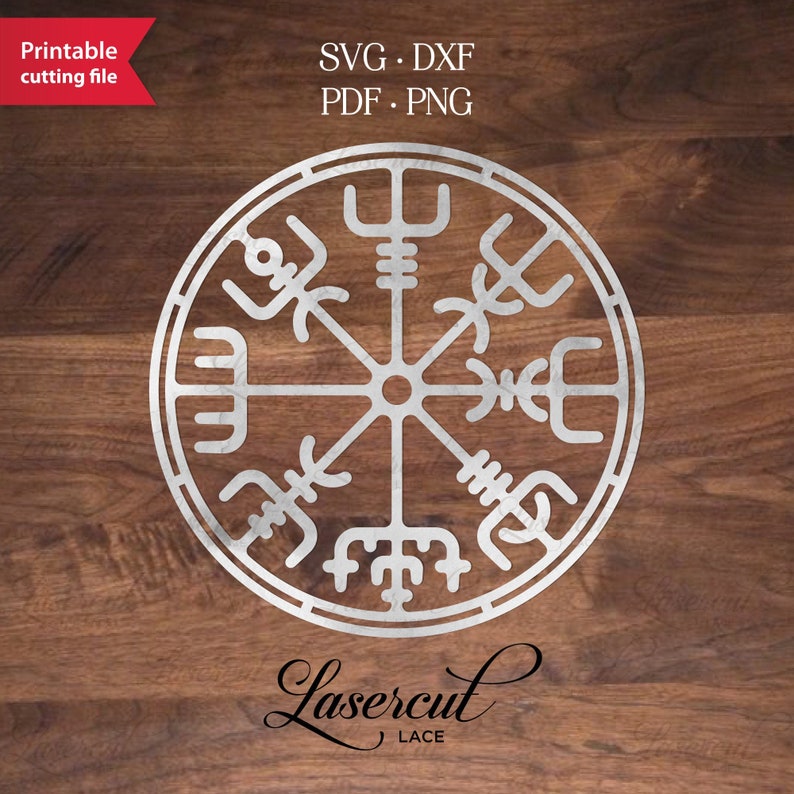 May include: A silver metallic compass with a circular design and intricate details. The compass is on a wood background with the text "Lasercut Lace" below it.
