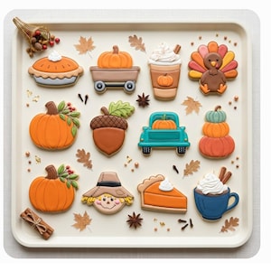 May include: A collection of autumn-themed sugar cookies arranged on a square tray, featuring shapes of pumpkins, a turkey, a scarecrow, pies, a truck, a mug, and an acorn, decorated with icing in orange, brown, blue, and white, with scattered spices.