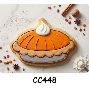 May include: A sugar cookie shaped like a pumpkin pie with orange icing, a tan crust, a grey base, and a white dollop of icing on top. The cookie is decorated with small sprinkles shaped like leaves, pumpkins, and acorns, with the text CC448 below.