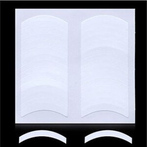 May include: A sheet of white double-sided eyelash tape with 30 individual adhesive strips. The tape is designed to lift and hold eyelashes in place.