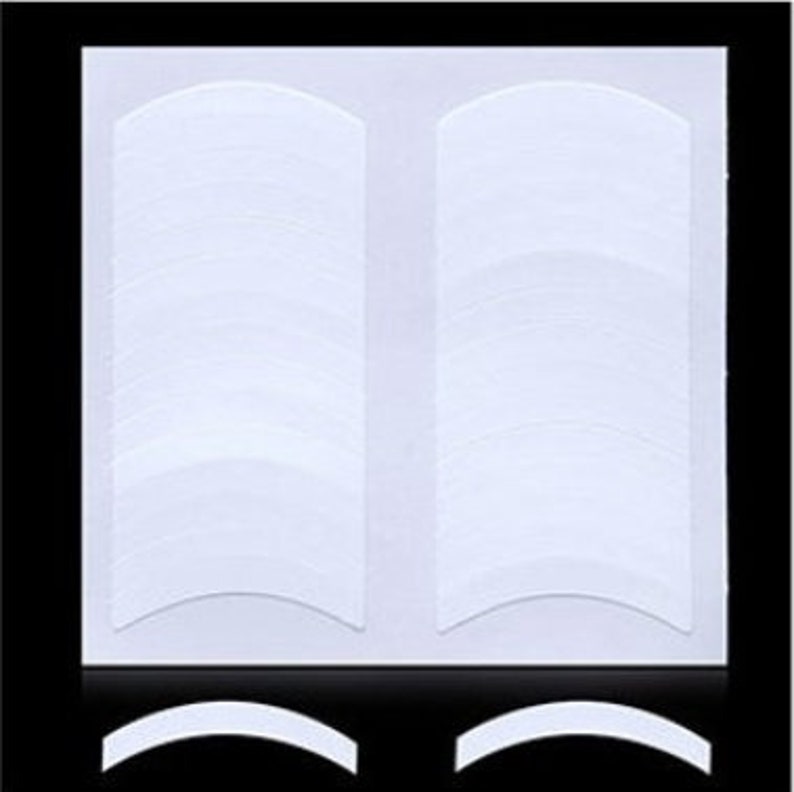 May include: A sheet of white double-sided eyelash tape with 30 individual adhesive strips. The tape is designed to lift and hold eyelashes in place.
