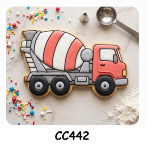 May include: A cement mixer truck shaped cookie decorated with red, white, and grey icing. The truck features a red cab, a striped rotating drum, and three black wheels. The cookie is surrounded by colorful sprinkles and a dusting of white flour.