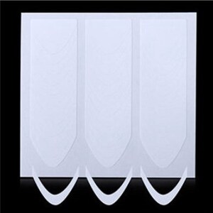 May include: Three white nail guide stickers on a white background. The stickers are shaped like a crescent moon and have a textured surface.