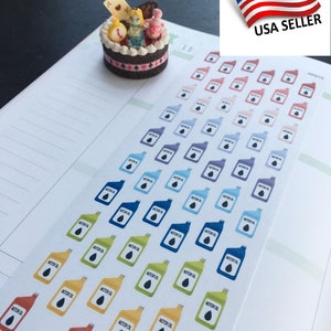 May include: A sheet of colorful stickers featuring a cartoon oil can with the text "MOTOR OIL". The stickers are arranged in rows and columns on a white background. The stickers are in various colors, including red, orange, yellow, green, blue, and purple.