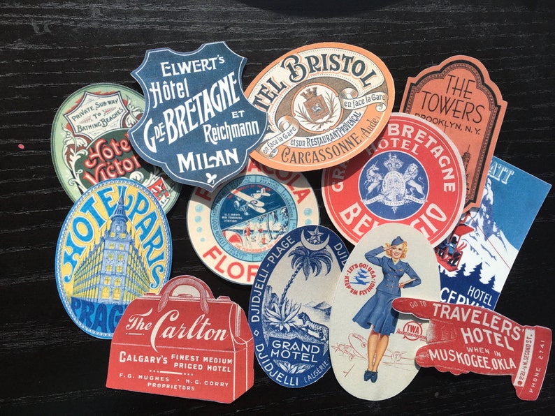 May include: A collection of vintage hotel stickers with various designs and colors. The stickers feature names like "Hotel Victor", "Hotel Paris", "The Carlton", "Grand Hotel", "Hotel Bretagne", "The Towers", and "Travelers Hotel".