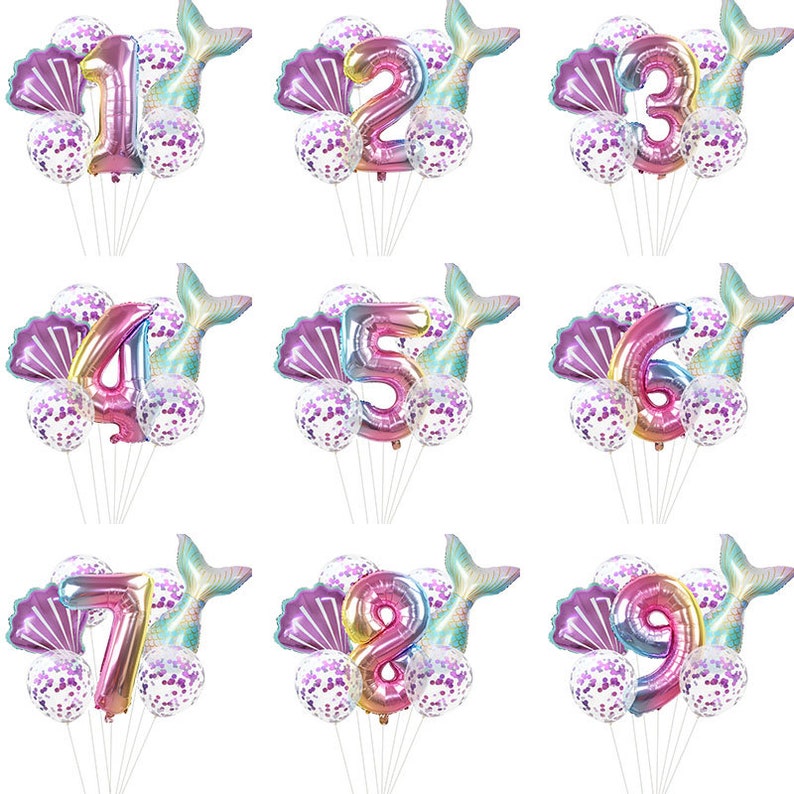 May include: Set of nine iridescent rainbow foil number balloons, each with a mermaid tail and seashell balloons. The numbers are 1 through 9.