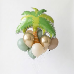 May include: A tropical-themed balloon bouquet featuring a large palm tree-shaped balloon in green and yellow, with a brown trunk. Accompanying the palm tree are several smaller balloons in shades of gold, beige, and green, tied together with white ribbons.