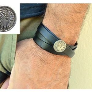 May include: A black leather bracelet with a silver-toned Native American headdress charm.