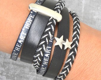 May include: Black leather bracelet with silver stars and the words "Love the My Hope" and "Love the Heart" engraved on it.