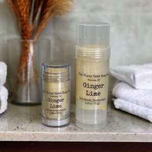 May include: Two clear plastic containers of natural deodorant with a yellow-toned product inside. The labels read "The Tipsy Goat Soap Co. Warsaw, IN Ginger Lime Handmade Deodorant" with the size in ounces and grams. The smaller container is 1.25 oz (35g) and the larger container is 2.5 oz (70g).