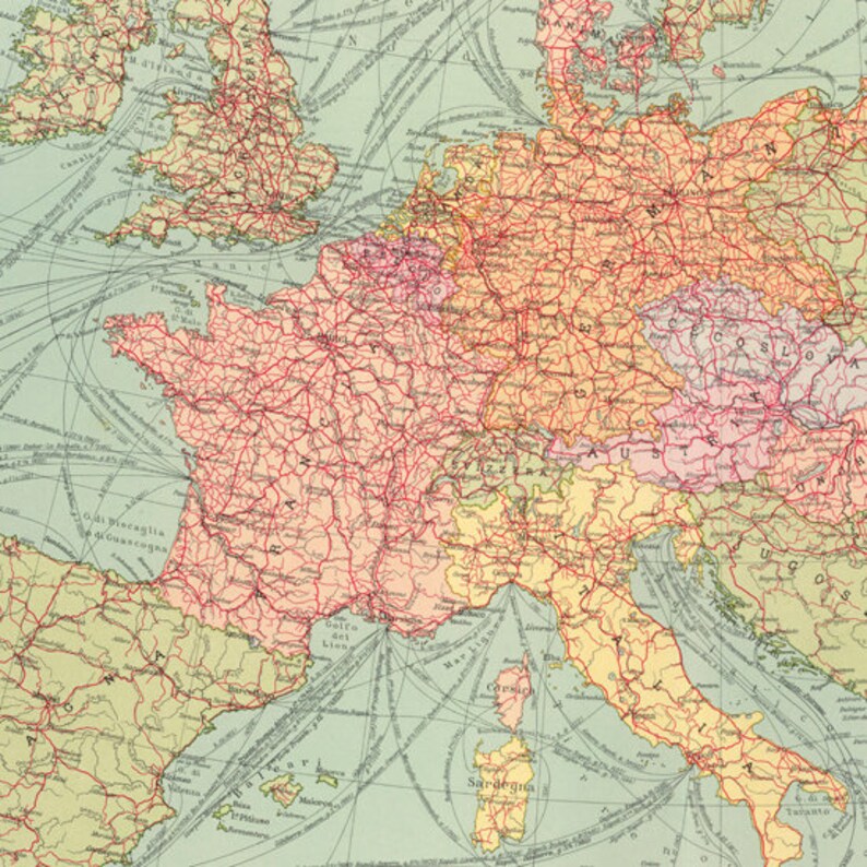 May include: A vintage map of Europe with red lines showing the major railway lines. The map is on a light blue background with yellow, pink, and green colors representing different countries. The map includes the names of major cities and countries.