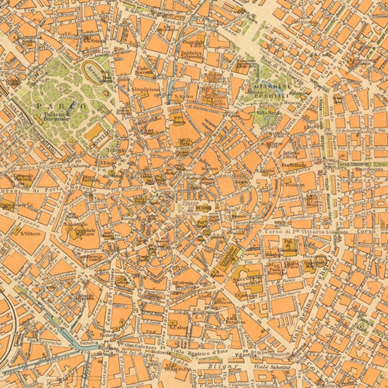 May include: A vintage map of Milan, Italy, with detailed street names and landmarks. The map is printed in shades of orange and brown on a cream-colored background.