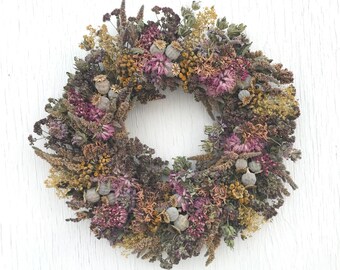 Herb wreath with common oregano, lavender, alchemilla, tansy, seedpods, anise hyssop, bay leaves, ornamental onions, chive blossoms