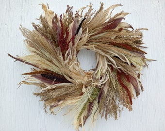 grain wreath with corn husks, sorghastrum, wheat, corn tassels, red amaranth, green amaranth, gold amaranth, miscanthus, purple majesty