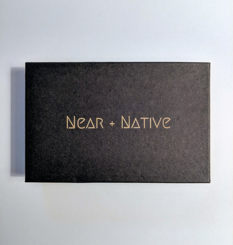 May include: A black box with the text "NEAR + NATIVE" printed in gold on the front.