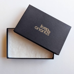 May include: A black box with a gold logo that reads "liveananta" is open, revealing a white tissue paper lining.