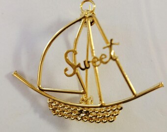 Vintage sailboat brooch, gold-tone with "Sweet" attached.