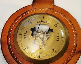 Vintage sure 4 cast  Barometer and weather forecaster with leather backdrop
