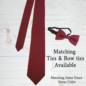 May include: A burgundy tie and bow tie set. The tie is long and straight, and the bow tie is pre-tied with an adjustable black band. The text "Matching Ties & Bow ties Available" and "Matching Same Exact Dress Color" is also visible.