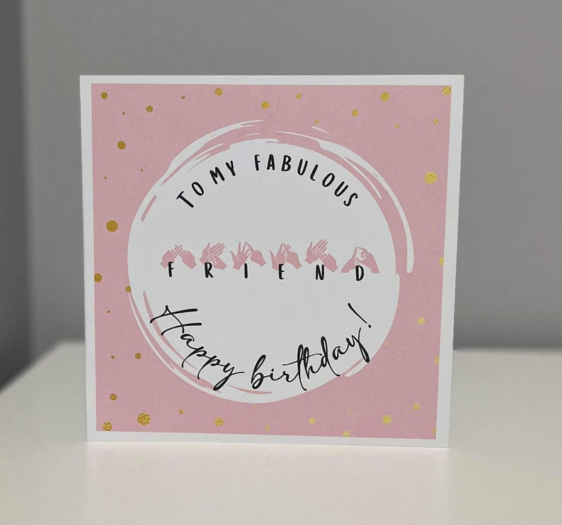 May include: Pink birthday card with gold glitter dots. The card says "To my fabulous friend!" with the word "friend" spelled out in sign language.