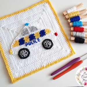 May include: A crochet square featuring a white police car with yellow and blue stripes, a red light, and the word "POLICE" on the side. The square has a yellow border and is surrounded by yarn in various colors, including white, yellow, blue, turquoise, red, gray, and black.