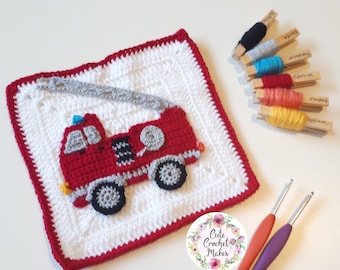 May include: A handmade crochet square featuring a red firetruck design on a white background with a red border. The firetruck has black wheels, a gray ladder, and blue and yellow accents. The image also shows colorful yarn and crochet hooks.