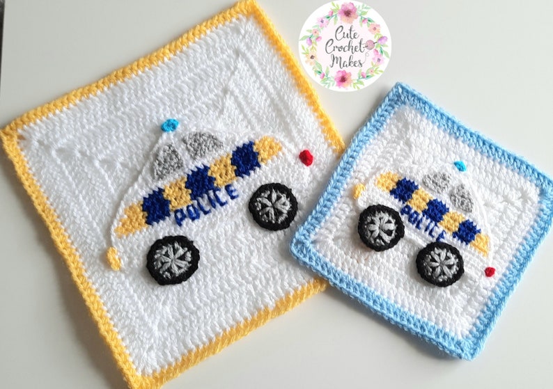 May include: Two crocheted squares with a police car design. The larger square has a yellow border and the smaller square has a blue border. Both squares are white with a blue and yellow police car design. The word "POLICE" is written on the car.