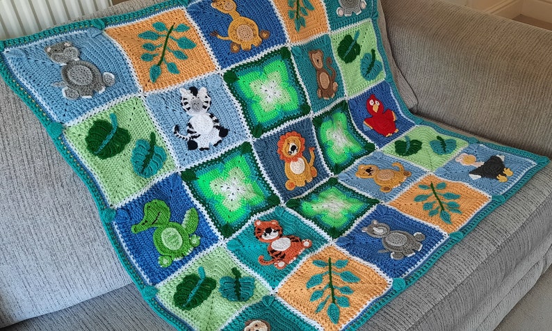 May include: A crocheted baby blanket with a jungle animal theme. The blanket features a variety of animals, including a zebra, a lion, a turtle, a monkey, and a bird. The blanket is made with a variety of colors, including green, blue, orange, and yellow.