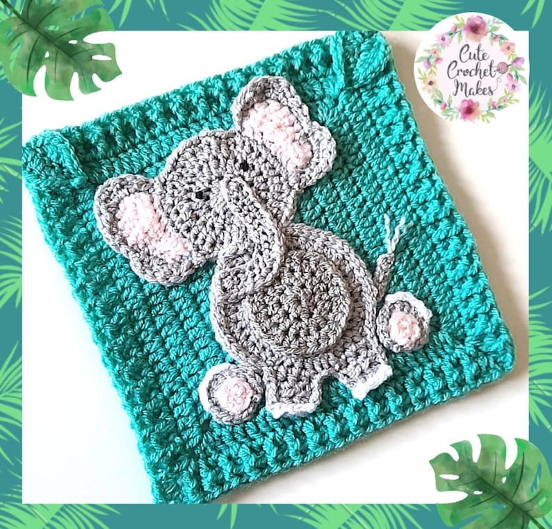 May include: A teal crocheted square with a gray crocheted elephant applique. The elephant has pink ears and a white outline.