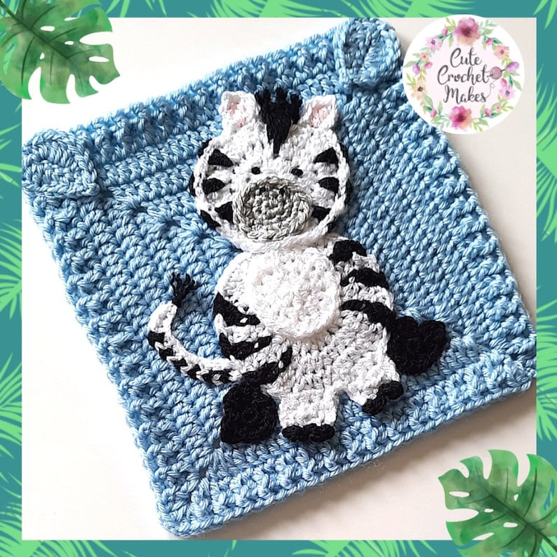 May include: A blue crocheted square with a white and black crocheted zebra appliqu&eacute;. The zebra has a black and white striped body, a black nose, and black hooves. The square has a white border and the text "Cute Crochet Makes" is in the upper right corner.