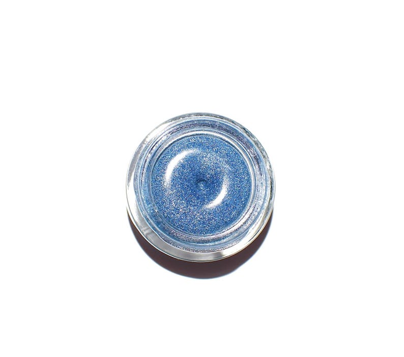 Pu&ograve; includere: Un piccolo barattolo rotondo di ombretto blu glitterato.