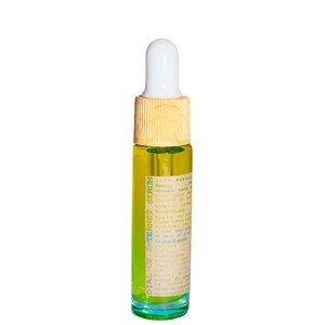 May include: A small, clear glass bottle filled with a yellow liquid, labeled "DIAL UP INTERNET SERUM." The bottle has a white dropper top and a light brown wooden cap. The label includes text about the product's ingredients and directions.