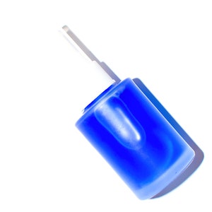 May include: A blue glass bottle with a white dropper top. The bottle is lying on its side.