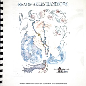 May include: A spiral-bound book cover with the title "BEADMAKERS' HANDBOOK." The artwork depicts hands holding a beaded necklace, with floral and blue abstract designs. The Fire Mountain Gems logo is present. The image is a watercolour illustration.