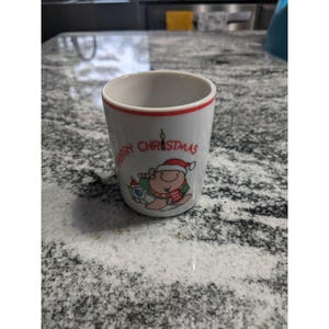 May include: A set of three ceramic mugs with a speckled, matte finish. The mugs are in shades of cream, light gray, and dark gray. Each mug has a simple, minimalist design and a rounded handle.