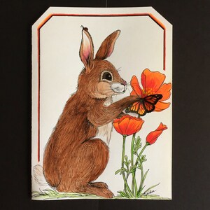 Curioso Brown Baby Rabbit con tarjeta de felicitación de mariposa 3D