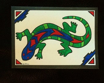 May include: A green, red, and blue stylized lizard illustration on a white background with a black border. The lizard is outlined in black and has a red and blue pattern on its back. The background has a red and blue geometric pattern in the corners.