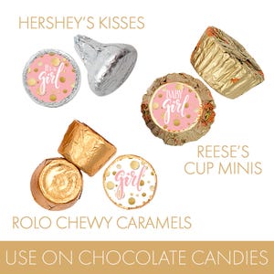 May include: An assortment of wrapped candies, including Hershey's Kisses, Reese's Cup Minis, and Rolo Chewy Caramels. The candies feature pink and gold accents with the phrases "It's a girl" and "Baby Girl". The text "Use on Chocolate Candies" is also visible.