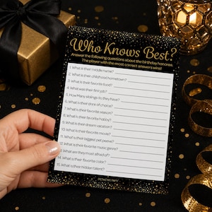 May include: A black and gold party game card with the text "Who Knows Best?" and fill-in-the-blank questions. The card is held by a hand, with a gold gift box and decorative items in the background.