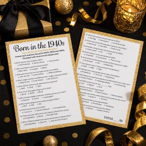 May include: Two trivia game cards with gold glitter borders and black text, asking questions about the 1940s, 1950s, and 1960s. The cards are on a black surface with gold decorations and a wrapped gift.