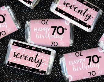 May include: Pink and black chocolate bar wrappers with confetti and the text "Happy 70th birthday" and "seventy".
