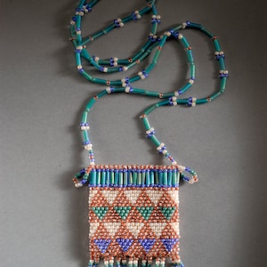 Amulet bag in brown, beige, dark turquoise and dark mauve seed and bugle beads.