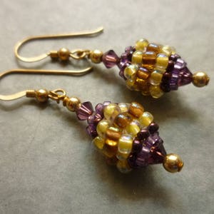 Beaded bead earrings in purple and gold, with rolled gold ear wires